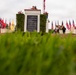 Sailors and Marine place flag at service members graves