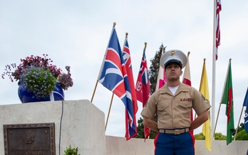 Sailors and Marine place flag at service members graves