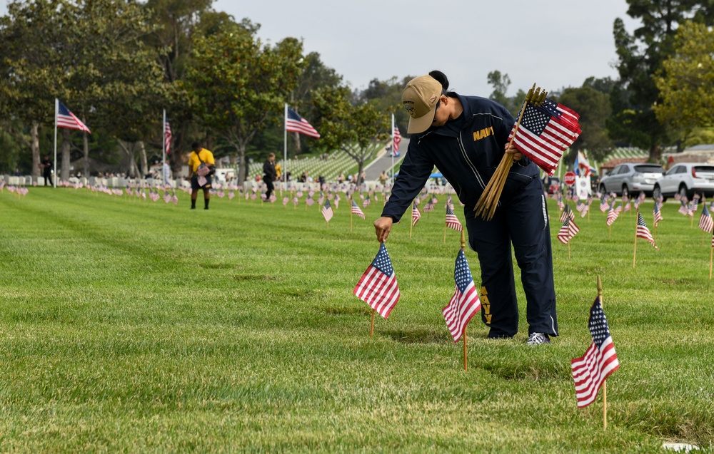 Sailors Place Flags on Service Member's Graves