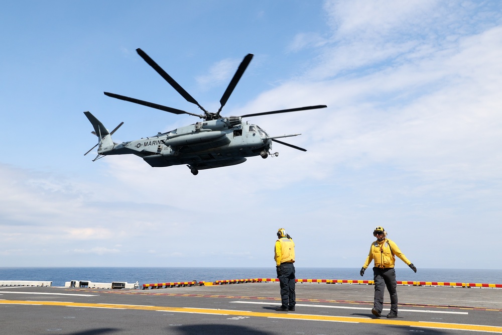 Air Department Sailors Signal Take Off to CH-53E Super Stallion