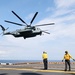 Air Department Sailors Signal Take Off to CH-53E Super Stallion