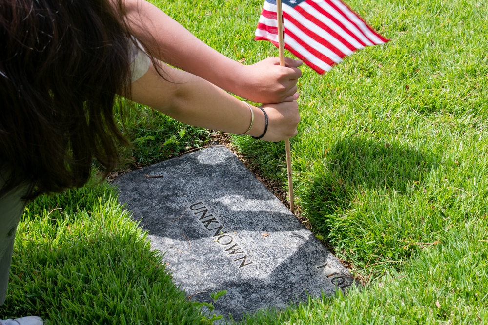 Boy Scouts place flags on unknown graves