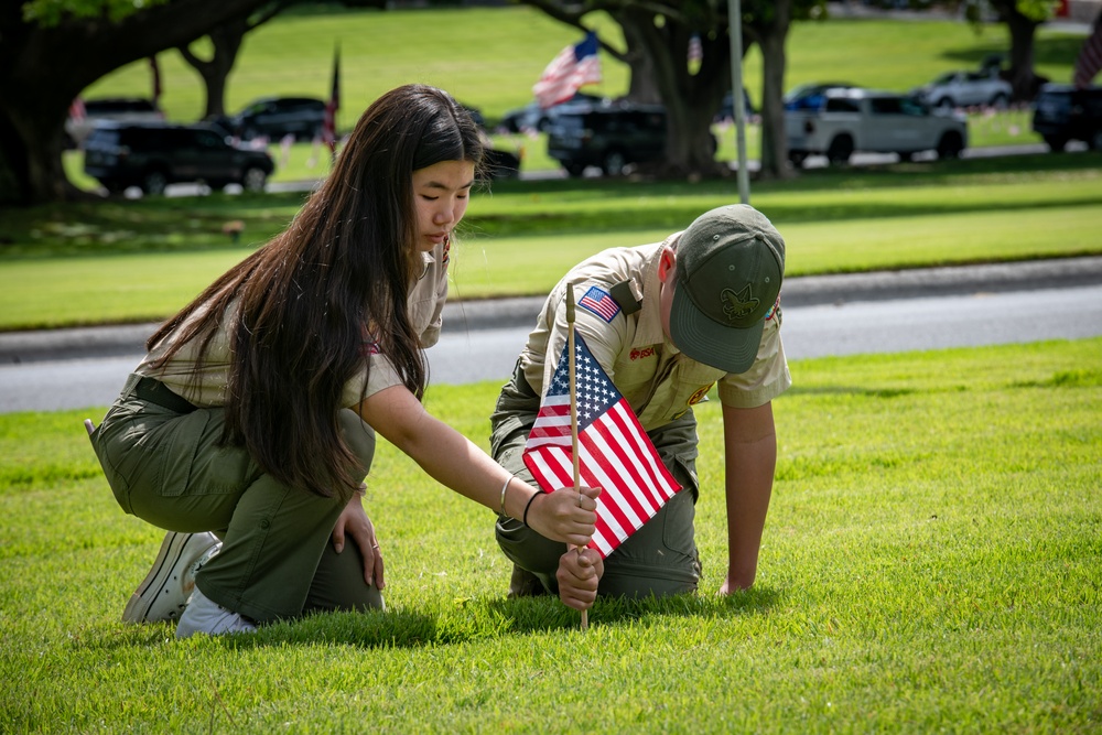 Boy Scouts place flags on unknown graves