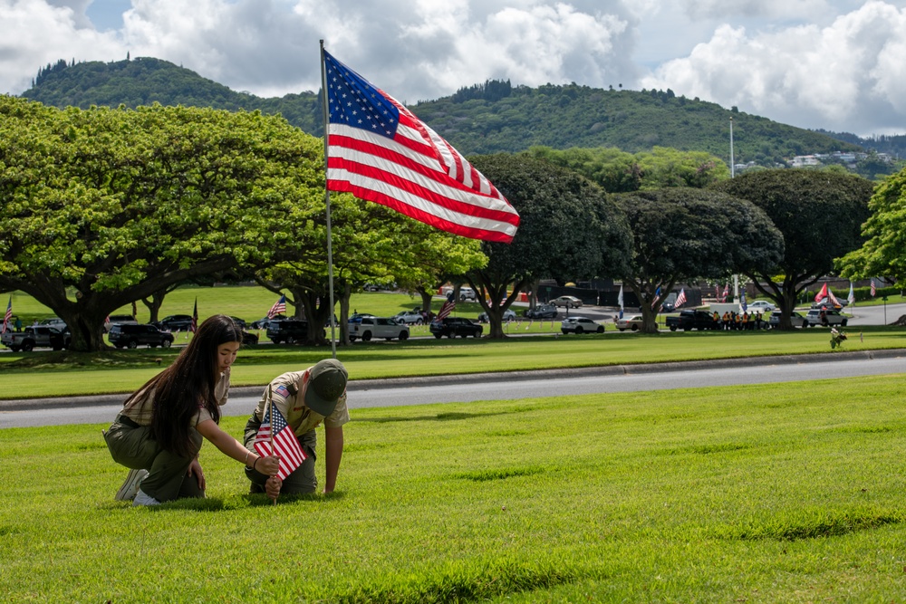 Boy Scouts place flags on unknown graves