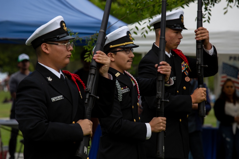 Service members attend the Sunset Sunset Ceremony at the Long Beach Navy Memorial during Los Angeles Fleet Week