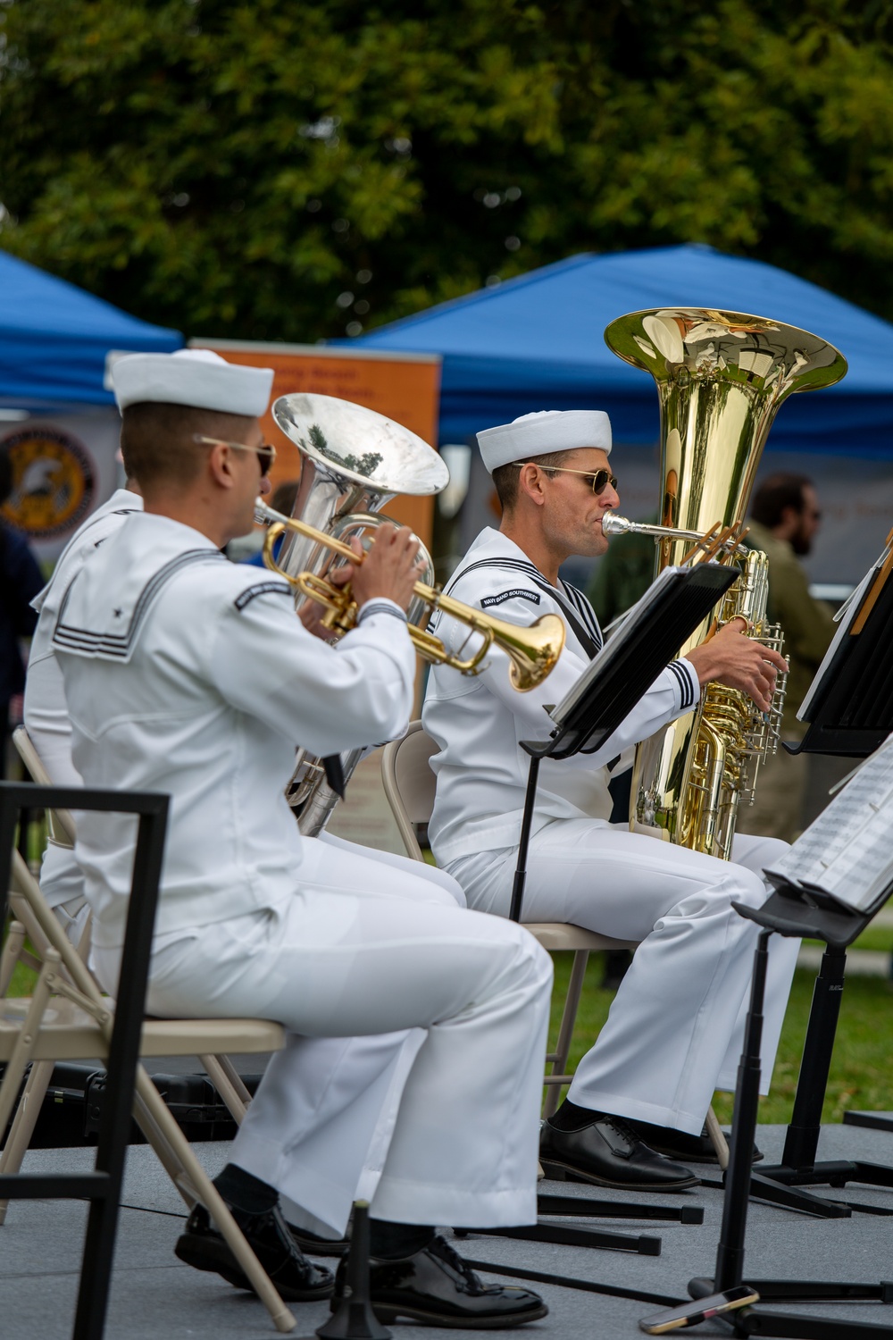 Service members attend the Sunset Sunset Ceremony at the Long Beach Navy Memorial during Los Angeles Fleet Week