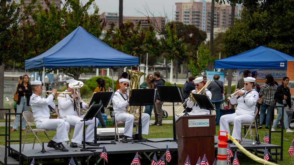 Service members attend the Sunset Sunset Ceremony at the Long Beach Navy Memorial during Los Angeles Fleet Week