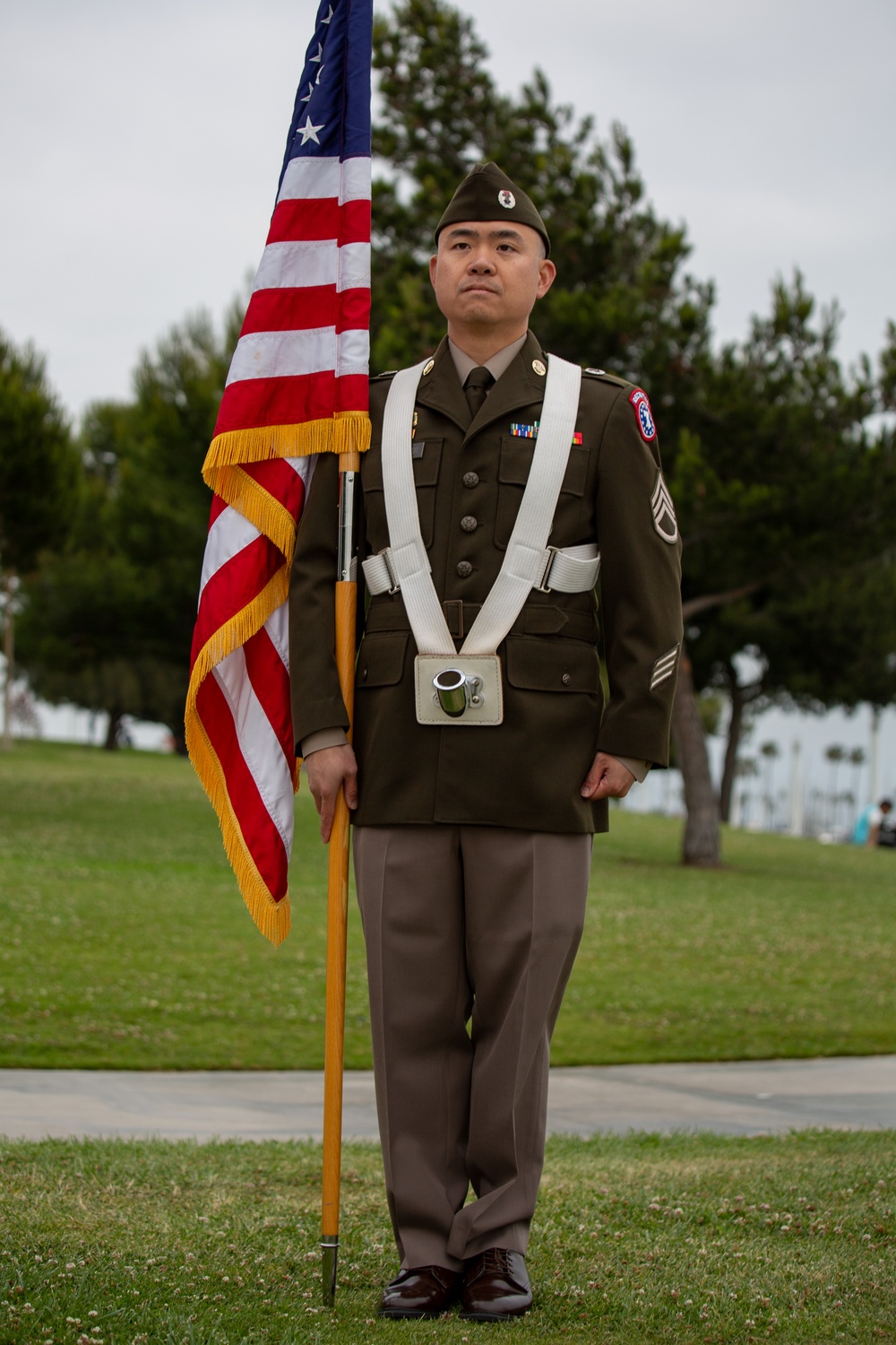 Service members attend the Sunset Sunset Ceremony at the Long Beach Navy Memorial during Los Angeles Fleet Week