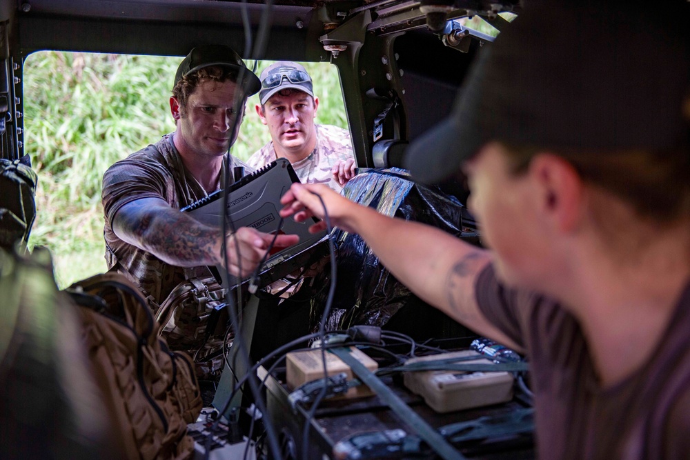 Sailors assigned to NMCB1 and SRT1 Work to Clear Fuel Depot Roads Following Typhoon Mawar