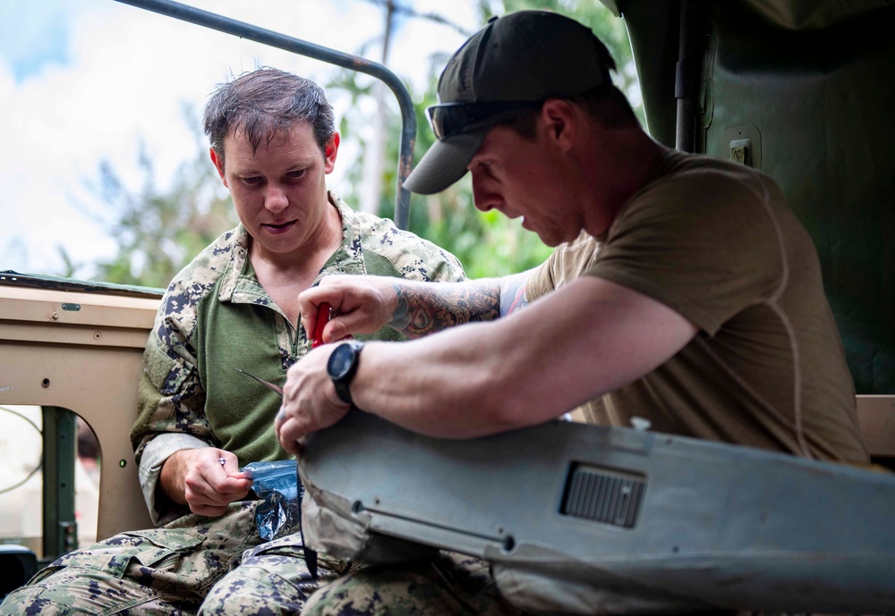 Sailors assigned to NMCB1 and SRT1 Work to Clear Fuel Depot Roads Following Typhoon Mawar