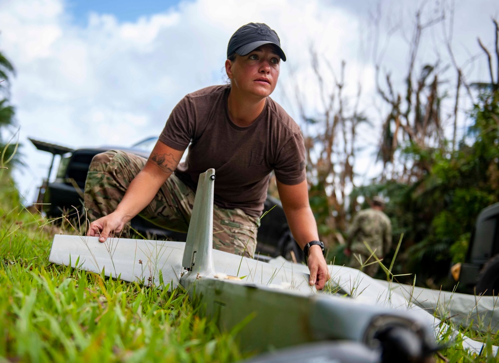 Sailors assigned to NMCB1 and SRT1 Work to Clear Fuel Depot Roads Following Typhoon Mawar