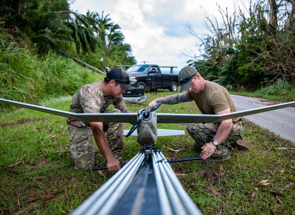 Sailors assigned to NMCB1 and SRT1 Work to Clear Fuel Depot Roads Following Typhoon Mawar