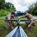 Sailors assigned to NMCB1 and SRT1 Work to Clear Fuel Depot Roads Following Typhoon Mawar