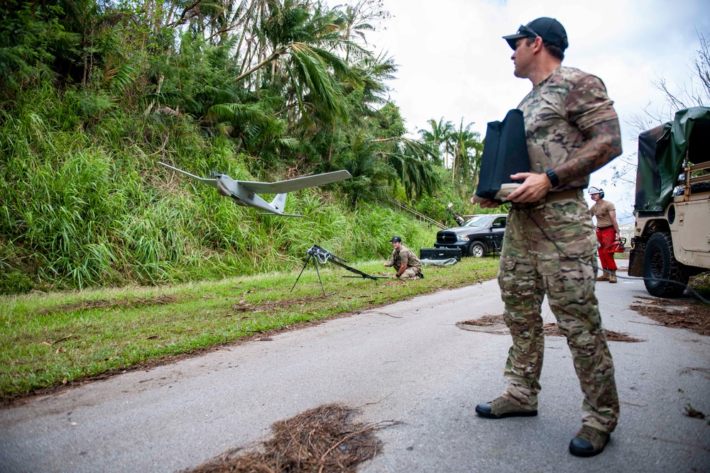 Sailors assigned to NMCB1 and SRT1 Work to Clear Fuel Depot Roads Following Typhoon Mawar