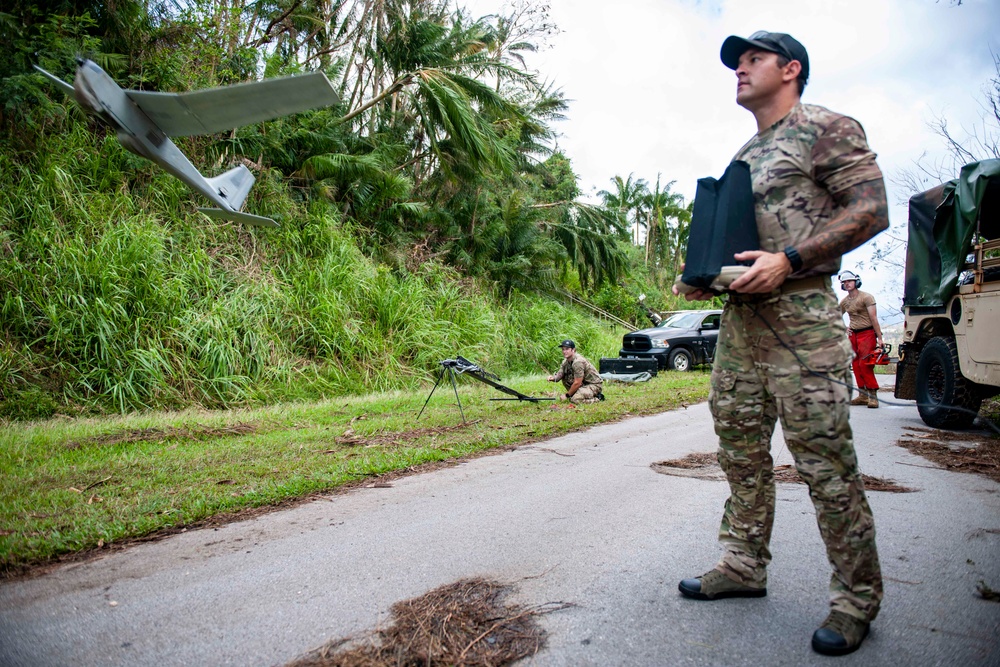 Sailors assigned to NMCB1 and SRT1 Work to Clear Fuel Depot Roads Following Typhoon Mawar