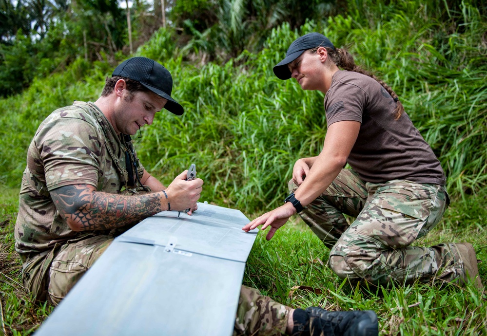 Sailors assigned to NMCB1 and SRT1 Work to Clear Fuel Depot Roads Following Typhoon Mawar