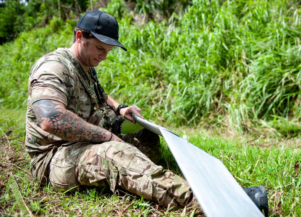 Sailors assigned to NMCB1 and SRT1 Work to Clear Fuel Depot Roads Following Typhoon Mawar