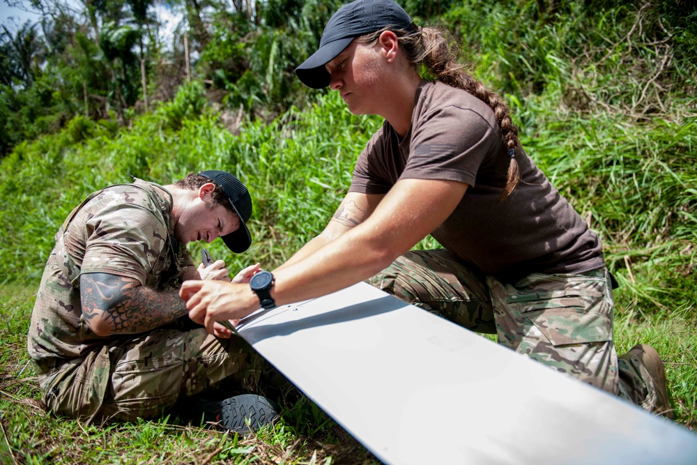 Sailors assigned to NMCB1 and SRT1 Work to Clear Fuel Depot Roads Following Typhoon Mawar