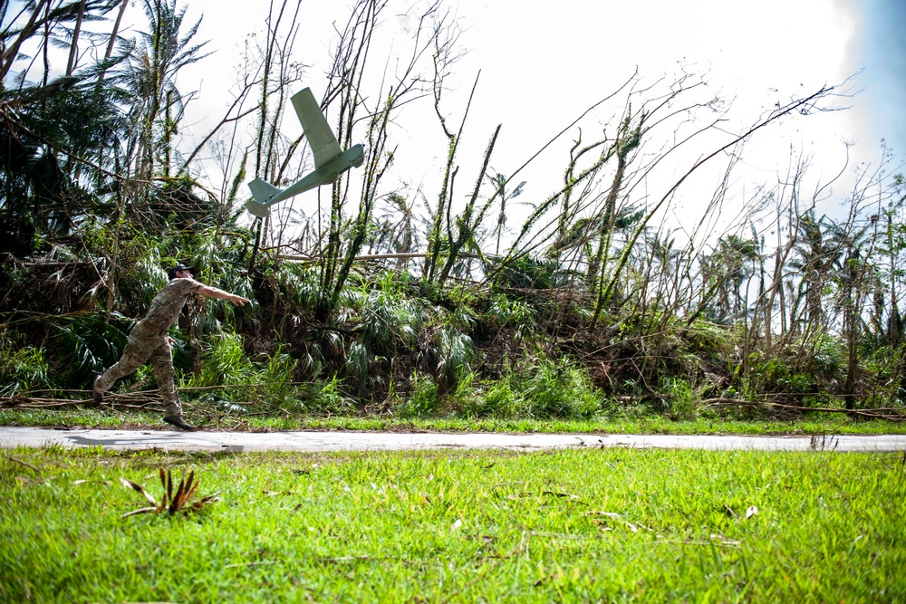 Sailors assigned to NMCB1 and SRT1 Work to Clear Fuel Depot Roads Following Typhoon Mawar