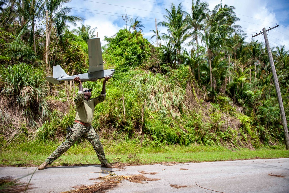 Sailors assigned to NMCB1 and SRT1 Work to Clear Fuel Depot Roads Following Typhoon Mawar