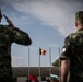 The Romanian flag is raised during the Saber Guardian opening ceremony