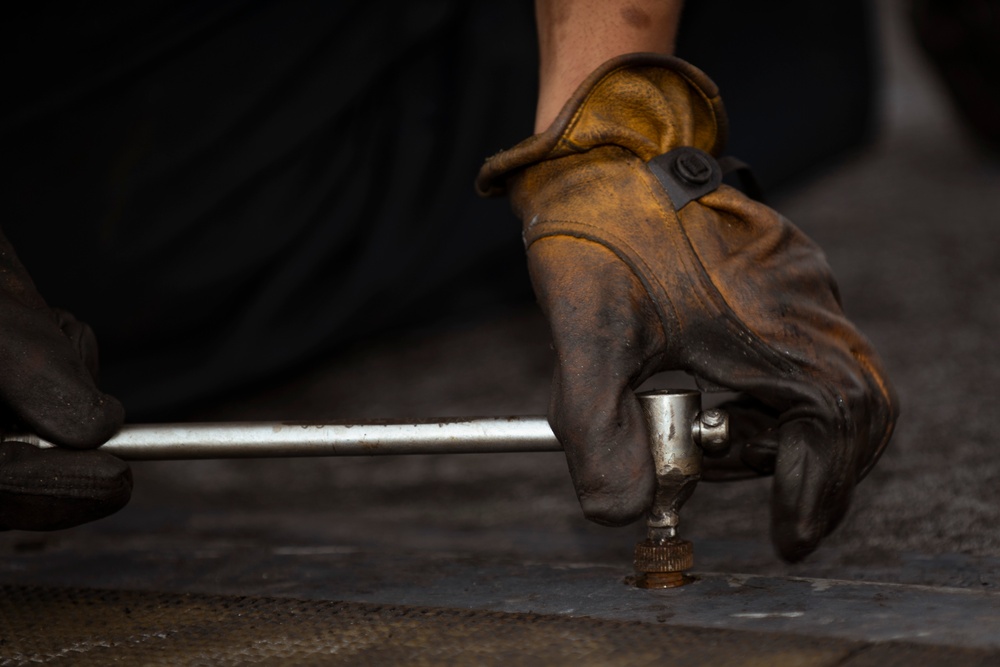 Sailor Performs Strike Pad Maintenance Aboard CVN 70