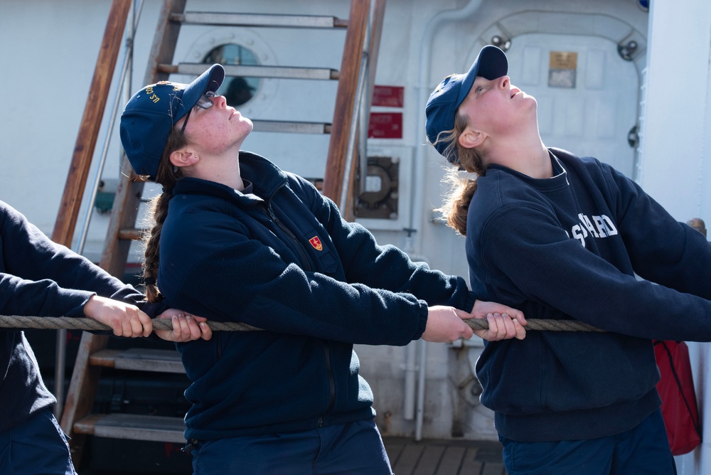 Coast Guard Cadets tug line on USCGC Eagle