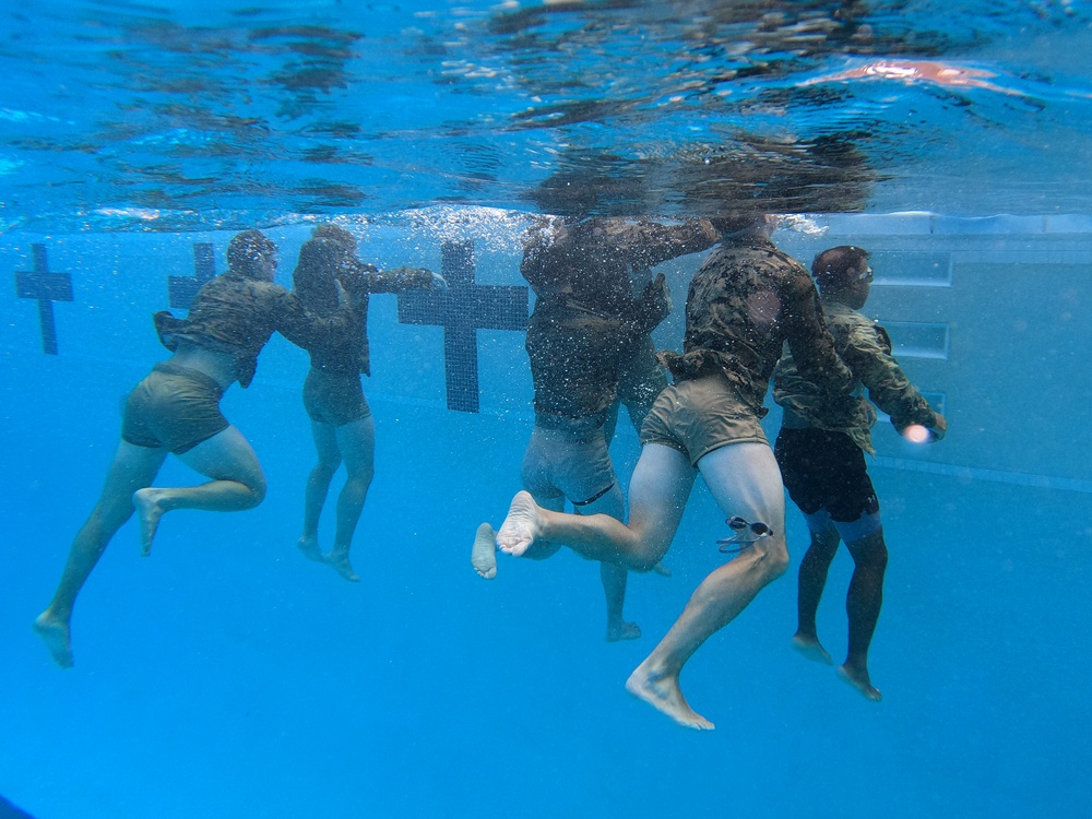 Servicemembers participate in Marine Corps Instructor of Water Survival course