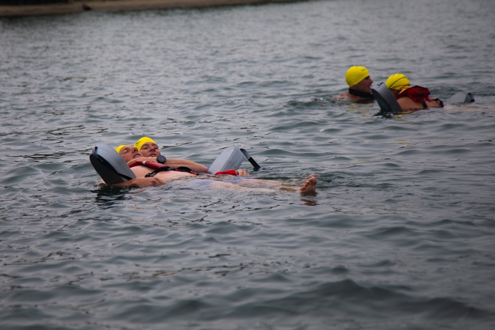 Servicemembers perform simulated rescues in Marine Corps Instructor of Water Survival course