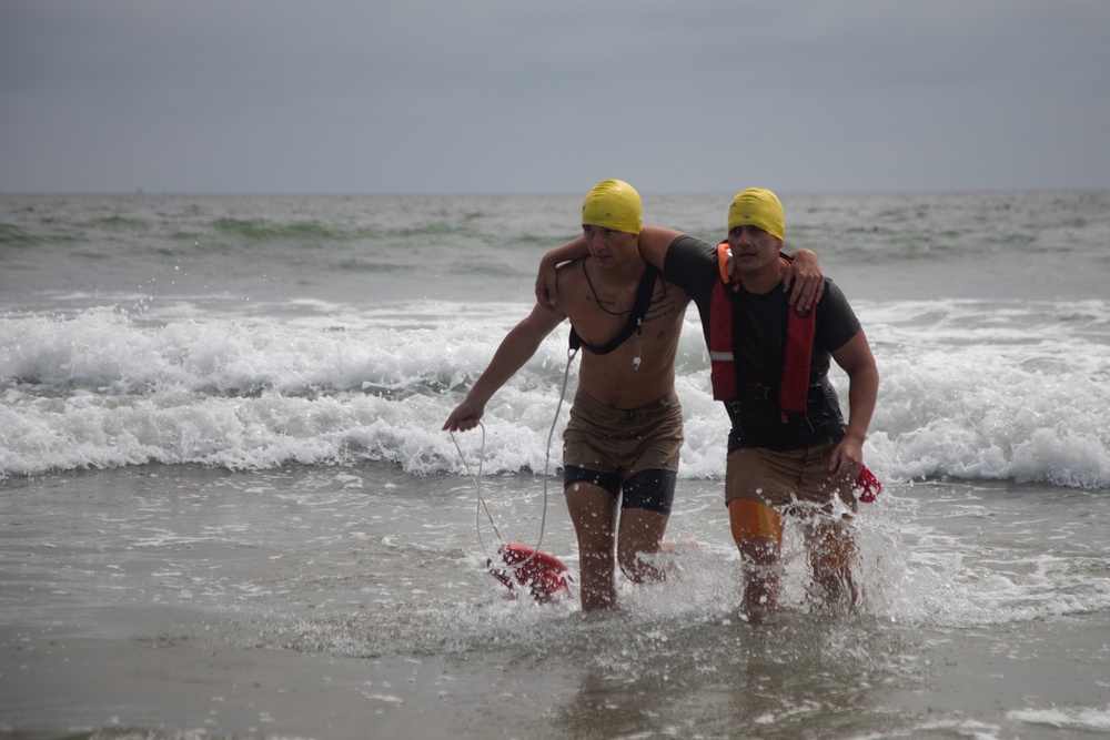 Servicemembers perform simulated rescues in Marine Corps Instructor of Water Survival course