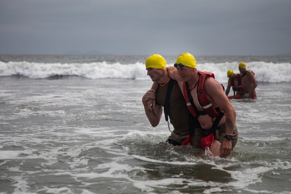 Servicemembers perform simulated rescues in Marine Corps Instructor of Water Survival course