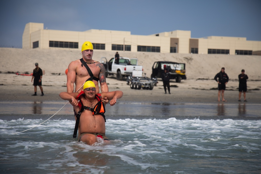 Servicemembers perform simulated rescues in Marine Corps Instructor of Water Survival course