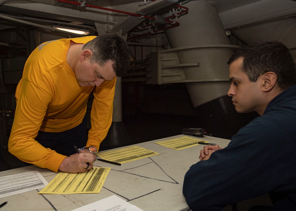 U.S Navy Sailor Signs Paper