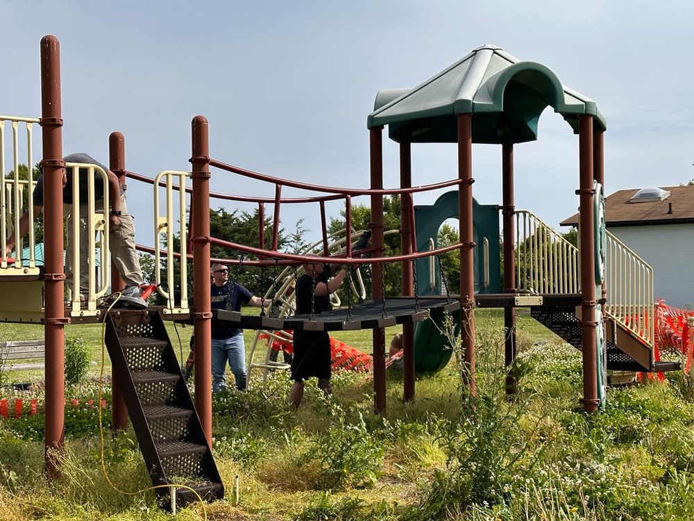 Pax Volunteers Dismantle Aging Equipment for New Playground Construction at Pax