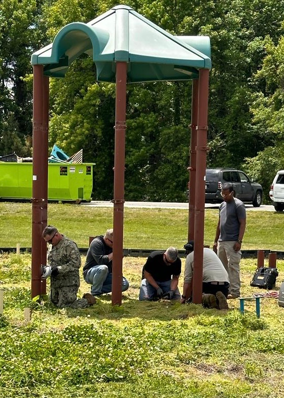 Pax Volunteers Dismantle Aging Equipment for New Playground Construction at Pax