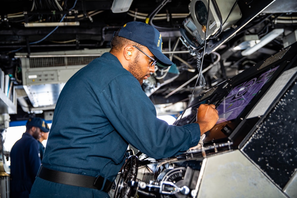 USS Robert Smalls (CG 62) Sailor Changes Helms Course in the Pilot House