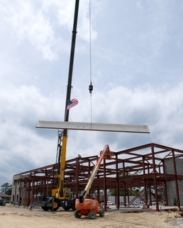 New Legal Services building receives special beam commemorating construction milestone
