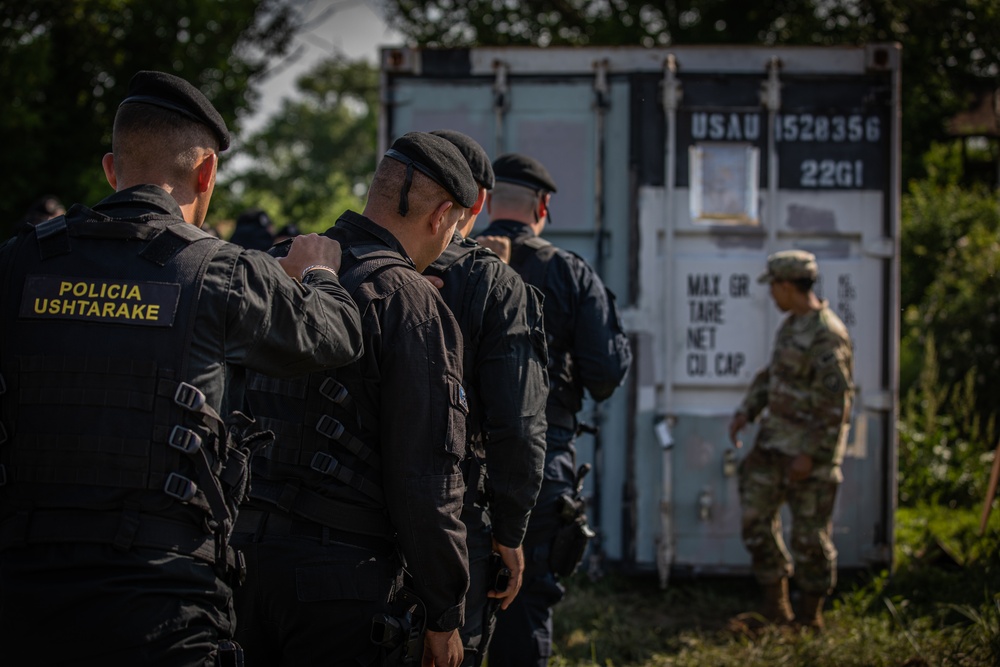 NATO military police forces train with U.S. military police by searching mock detention cells