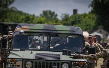 U.S. and NATO partner forces cooperatively train to tow and recover tactical vehicles