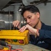 USS Ronald Reagan (CVN 76) Sailors troubleshoot plastic processer remote