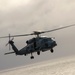 MH-60R Sea Hawk Helicopter Flies Near The Aircraft Carrier USS Nimitz