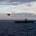 MH-60R Sea Hawk Helicopters Fly Near The Aircraft Carrier USS Nimitz