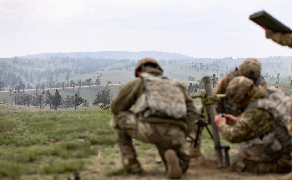 Iowa infantrymen prepare to fire 60 mm mortar