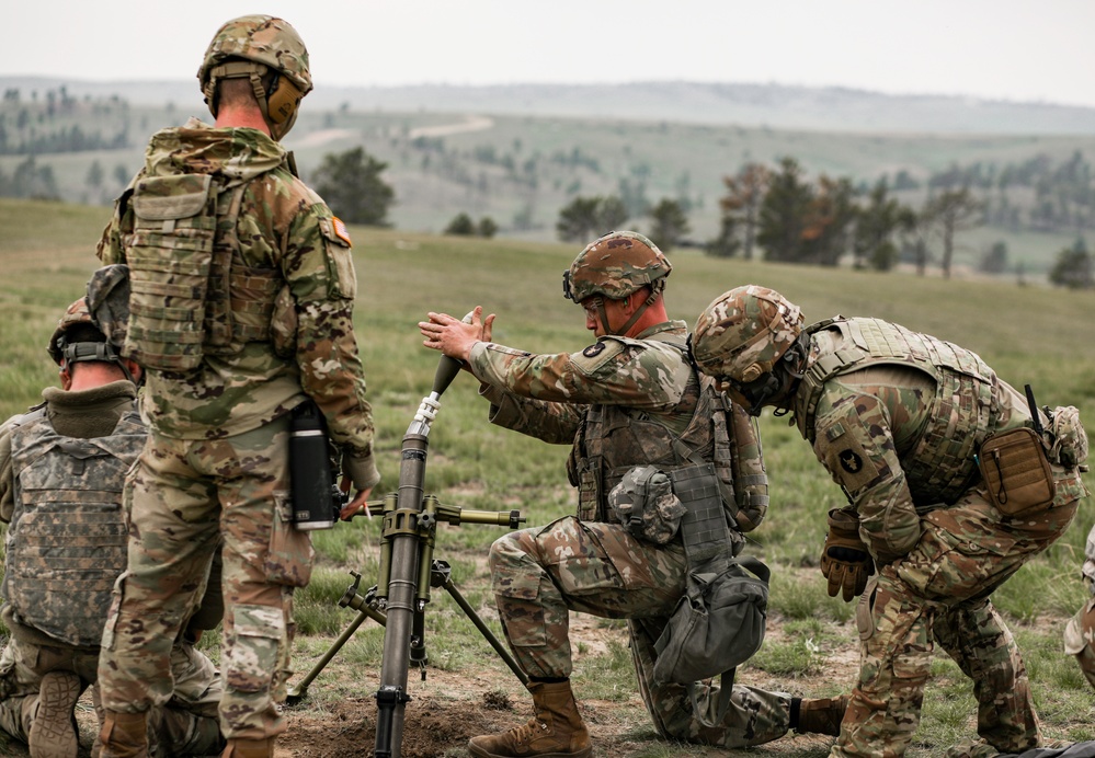 Iowa infantryman loads 60 mm mortar