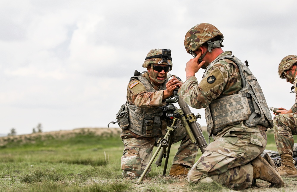 Iowa infantryman laods 60 mm mortar