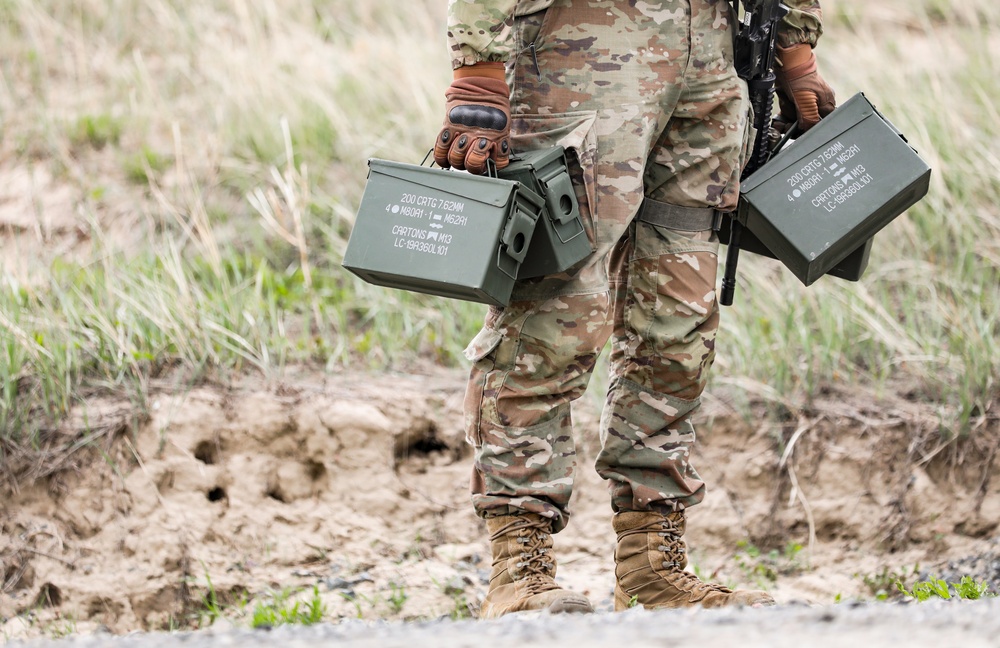 Iowa infantryman carries ammunition