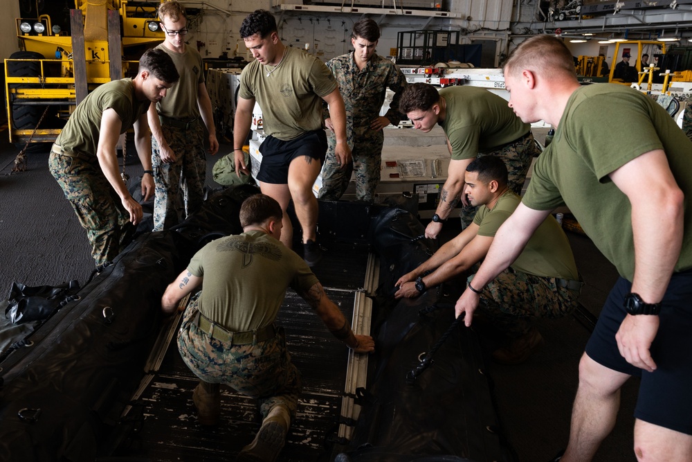 Marines assemble rafts on USS Bataan