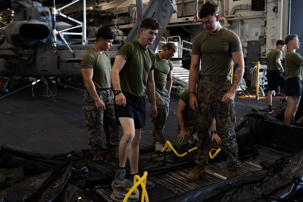 Marines assemble rafts on USS Bataan