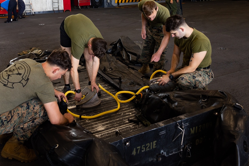 Marines assemble rafts on USS Bataan