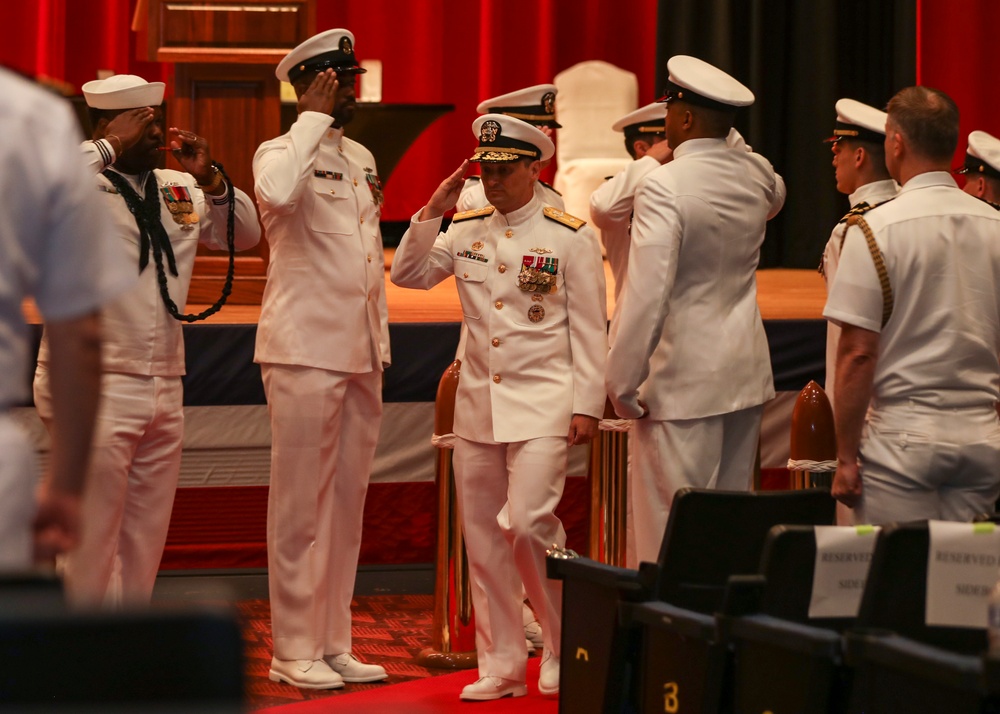 Rear Adm. Chris Cavanaugh salutes side boys during the Commander, Submarine Group 7 change of command ceremony